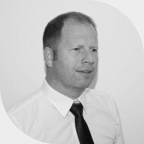 The Managing Director, Ian Livingstone wearing white shirt and black tie