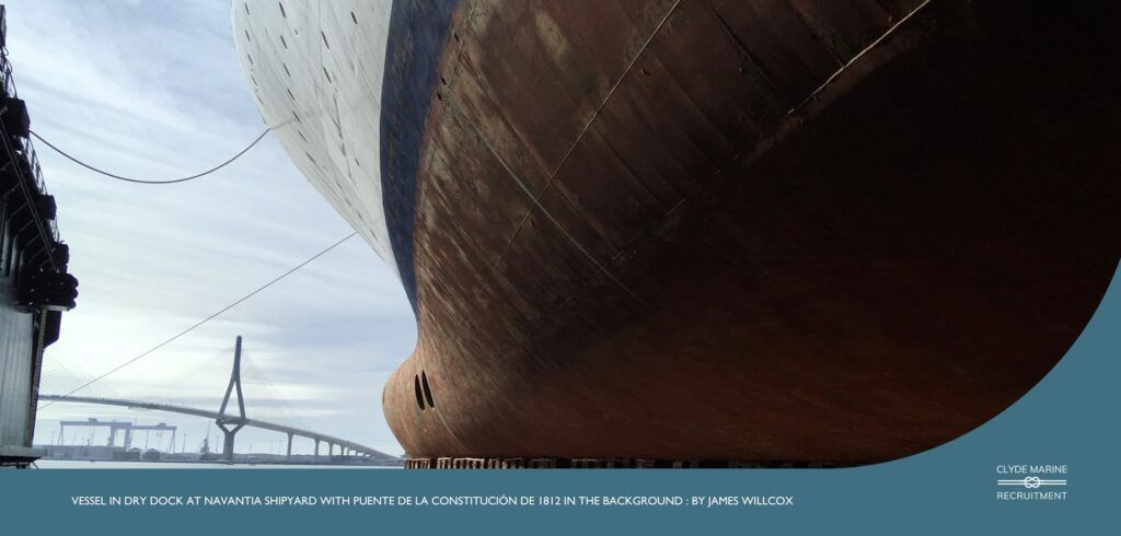 Vessel in dry dock at Navantia shipyard with Puente De La Constitución De 1812 in the background : By James Willcox
